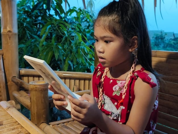 Students in a rural school setting in Bangladesh, using digital tablets for learning, indicating the integration of technology in education.
