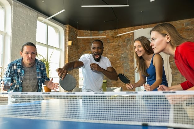 A group of young, aspiring table tennis players listening attentively to a coach during a training session as part of the talent search program.