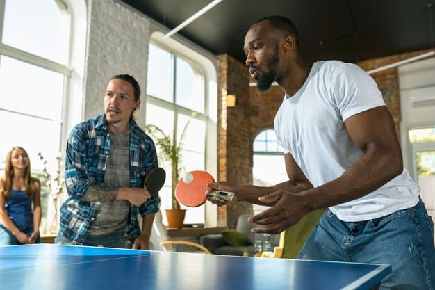 A coach providing personalized instruction to a young table tennis player during a practice session at the training camp organized by the federation.