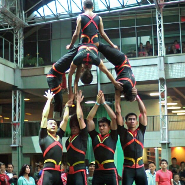 A Bangladeshi national gymnastics team poses with their coaches and federation officials, showing team spirit and support for the new training initiatives.