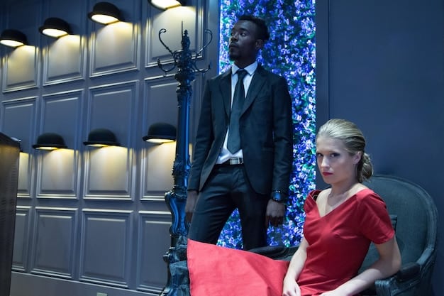 Actors in costume rehearsing their lines on set, with the director watching and giving feedback. The scene is well-lit and detailed.